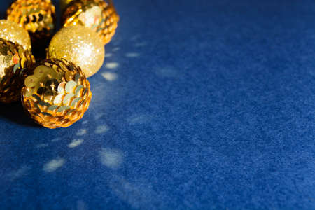 Christmas golden ornaments balls decoration on abstract blue backgroundの写真素材