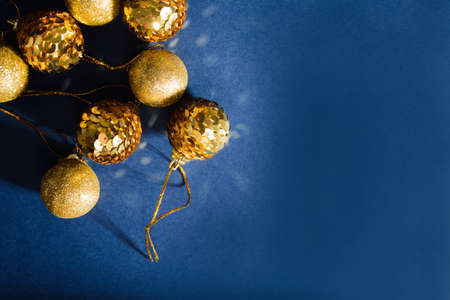 Christmas golden ornaments balls decoration on abstract blue backgroundの写真素材