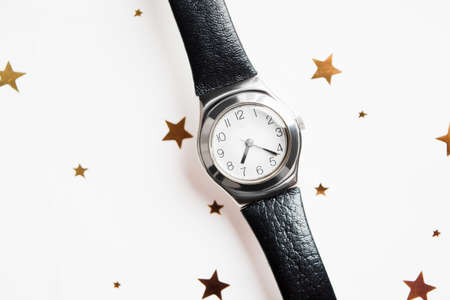 Woman wristwatch with black leather strap with golden starsの写真素材