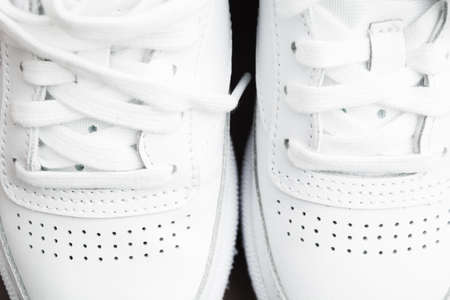 Closeup top view of pair of female stylish white casual sneakersの写真素材