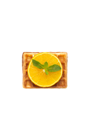 Belgium waffle with orange and mint on white isolated backgroundの写真素材