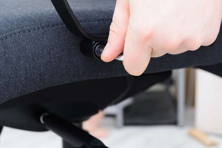 Man hands screw chair handle Assembling chair Step by step instructions Step 13の写真素材