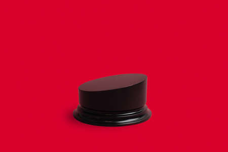 Single wooden geometric podium on red background with copy spaceの写真素材