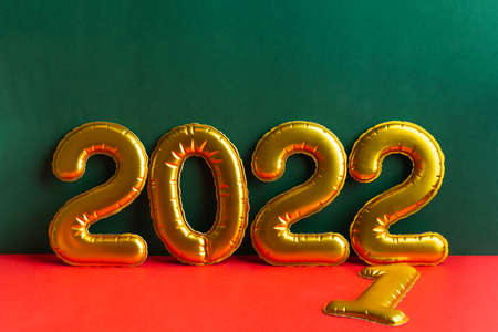 Golden numbers 2022 year inscription on green and red backgroundの写真素材