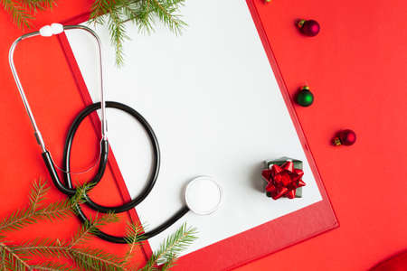 Medical Christmas concept with stethoscope, blank clipboard with white paperの写真素材