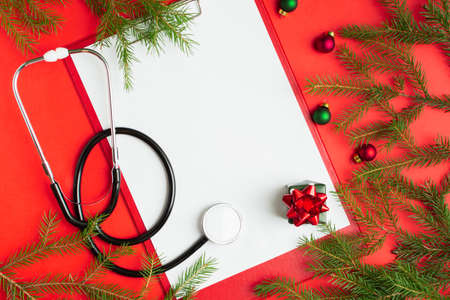 Medical Christmas concept with stethoscope, blank clipboard with white paperの写真素材