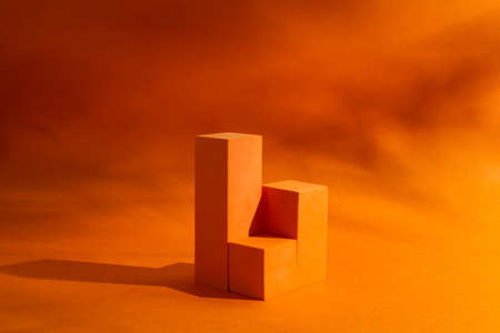 Showcase for cosmetic with interesting shadow on orange backgroundの写真素材