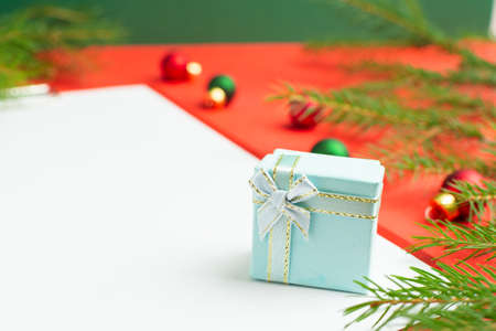 A list of Christmas wishes next to several small giftsの写真素材