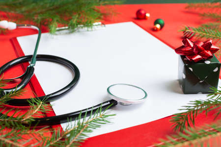 Medical Christmas concept with stethoscope, blank clipboard with white paperの写真素材