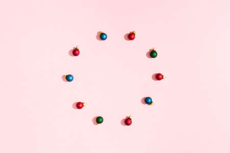 Circle of Christmas colorful balls on pink pastel paper backgrond and copy spaceの写真素材