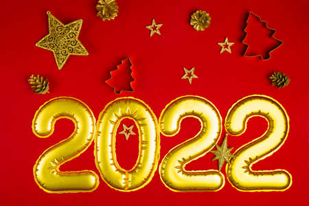 New Years concept red background with golden decorations 2022の写真素材