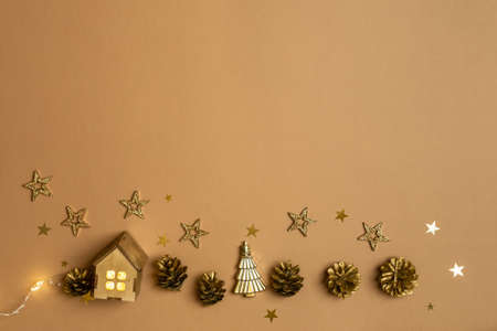 Christmas and New Year composition flat lay with golden decorations on brownの写真素材