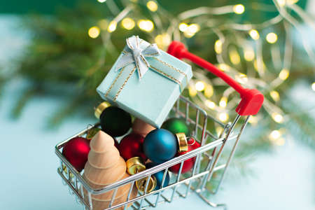 Christmas shopping concept with miniature trolley with decoration and gift boxの写真素材
