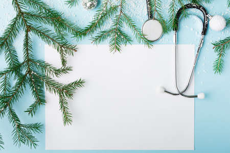 Christmas medical concept with stethoscope, face mask and christmas treeの写真素材