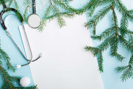 Christmas medical concept with stethoscope, face mask and christmas treeの写真素材