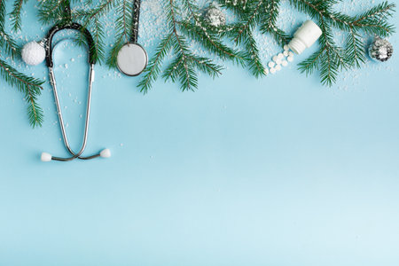 Christmas medical concept with stethoscope, face mask and christmas treeの写真素材