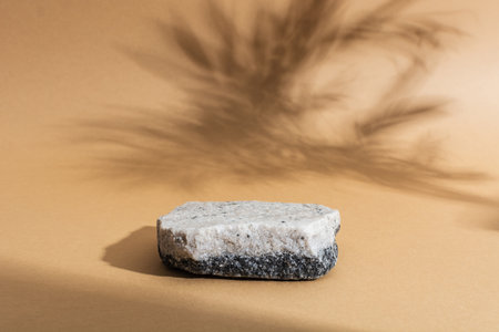 Stone podium with two colors on beige background with shadows. Mockupの写真素材