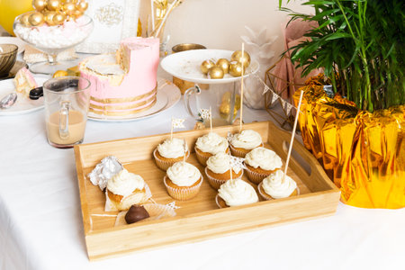 Table with leftovers after birthday with coffee, cake, cupcakesの写真素材