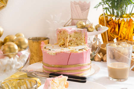 Table with leftovers after birthday with coffee, cake, cupcakesの写真素材