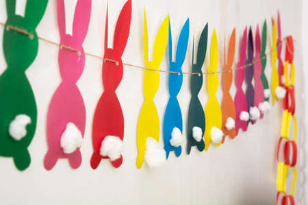 Handmade colorful paper garland with rabbits for Easter holidayの写真素材