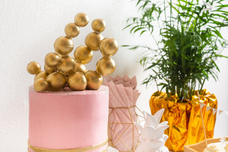 Holiday birthday table with cake and ballons. Pink and golden decorationの写真素材