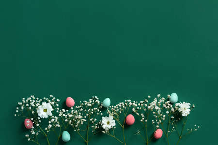 Easter beautiful flat lay with copy space with colorful eggs and flowers