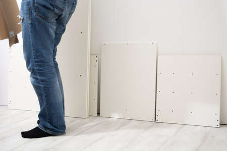 Assembly cabinet furniture. Do it youself concept. White chipboard interiorの写真素材