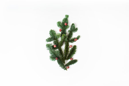 Christmas concept with green branches of fir tree with christmas ballsの写真素材