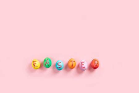Easter flat lay composition with colorful painted natural eggs on pink backgroundの写真素材