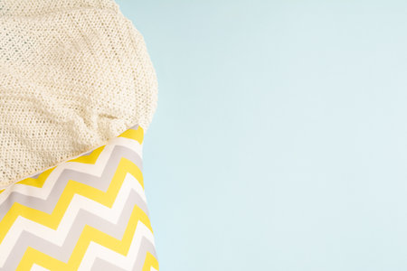 Pillow with zigzag pattern with textile plaid on blue backgroundの写真素材