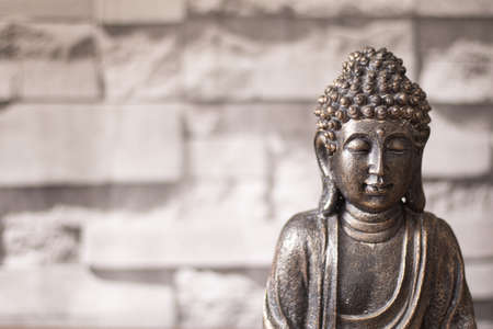 Buddha head in bronze, vertical with stone bottomの写真素材