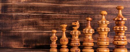 Wooden chess on wooden background