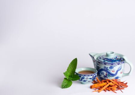 Chinese tea cup accompanied by red tea and peppermintの写真素材