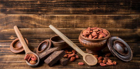 Cocoa and chocolate seeds on utensilsの写真素材
