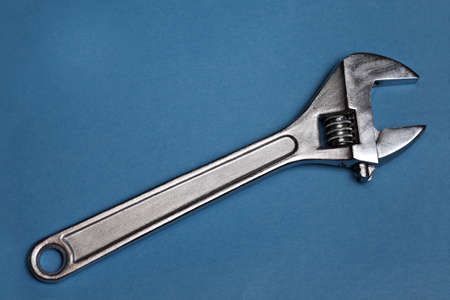 Adjustable steel wrench on blue backgroundの写真素材