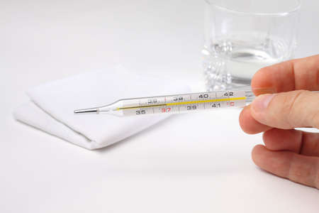 Medical mercury thermometer showing 37 degrees Celsius, possible illness