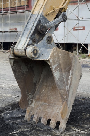 A rusty bucket of excavator at work siteの写真素材