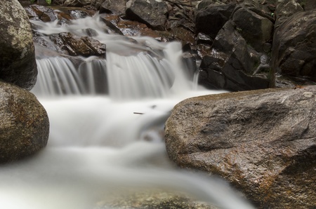The slow shutter of waterfall flows softly like fogの写真素材