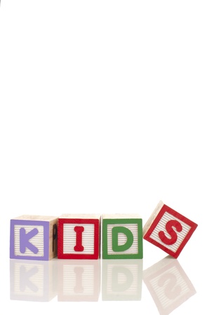 Kids word at wood blocks isolated on white backgroundの写真素材