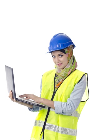 Beautiful muslim woman with personal protective equipment holding laptopの写真素材