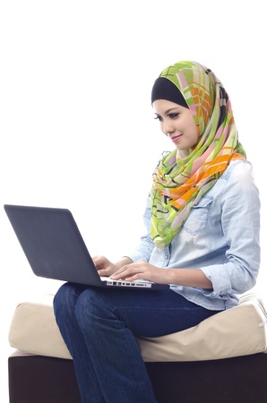 Beautiful muslim woman smiling chat with her friends using computerの写真素材