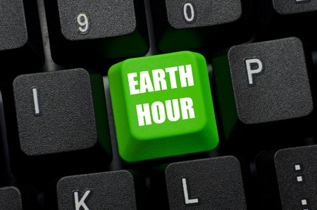 earth hour on green and black keyboard buttonの写真素材