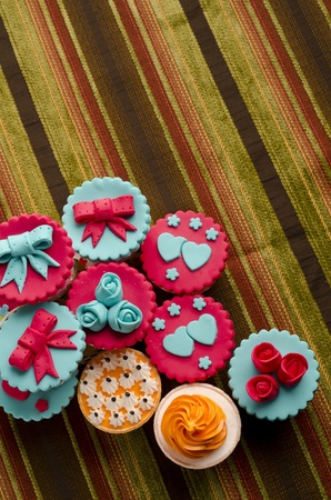 Colorfull cup cakes isolated on cotton backgroundの写真素材