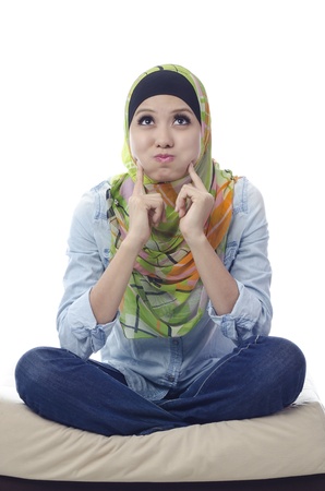 Beautiful muslim woman with mocking face isolated on white backgroundの写真素材