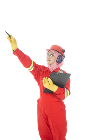 A woman complete with personal protective equipment at work site の写真素材