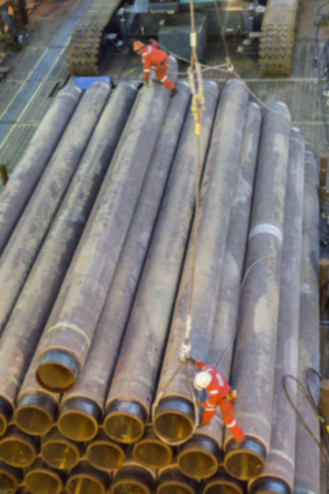 Motion blur of Riggers performing lifting activity for oil and gas pipeline using crawler crane.の写真素材