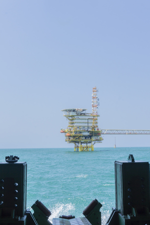 View from pipeline tunnel through to the ocean and oil rig platform.の写真素材