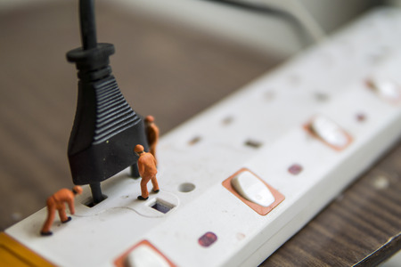 Miniature figures electrical installation - Close up of electrician workers teamwork concept with selective focus.の写真素材