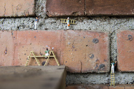 Miniature figure working in industrial sector - Close up of cleaning and painting workers teamwork concept with selective focus.の写真素材
