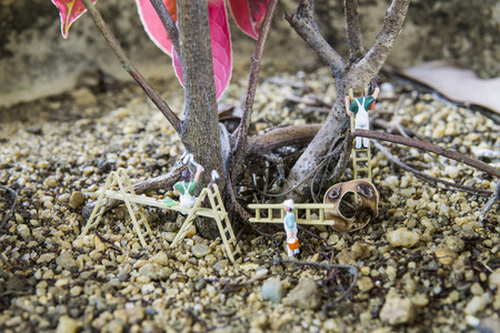 Miniature figure working in industrial sector - Close up of workers teamwork concept with selective focus.の写真素材